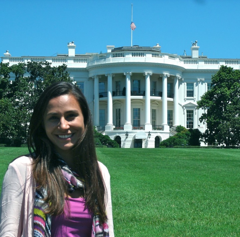 Young woman smiles in front of the White House