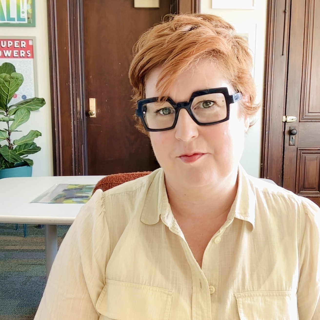 Redheaded middle aged woman sitting in an office
